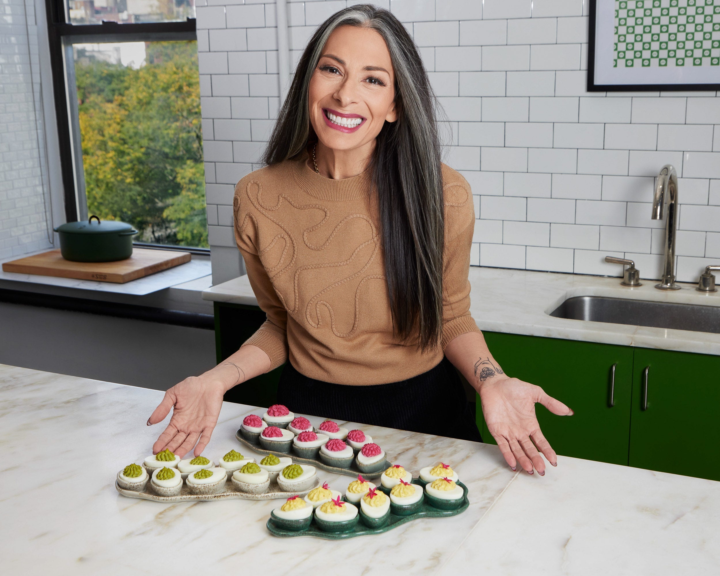 stacy london poses with her haand deviled egg trays